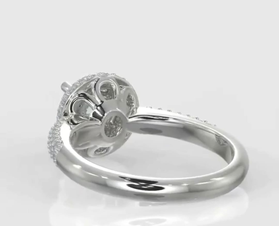 Angled rear profile highlighting the intricate scalloped undercarriage and diamond pavé details of a halo engagement ring.