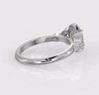 Side profile of a white gold vintage style engagement ring featuring an oval lab grown diamond and intricate floral diamond accents on the band.