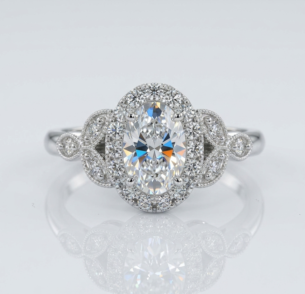 Top-down view of a vintage-inspired 2 carat oval lab grown diamond ring featuring a sparkling halo and symmetrical floral diamond side stones.