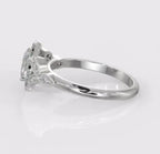 Angled side view of an oval cut diamond halo ring emphasizing the smooth lower shank gently curving into the detailed milgrain diamond leaf shoulders.