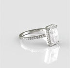 Angled top view of a radiant cut diamond engagement ring highlighting its elongated rectangular shape, delicate pavé halo, and brilliant facets.