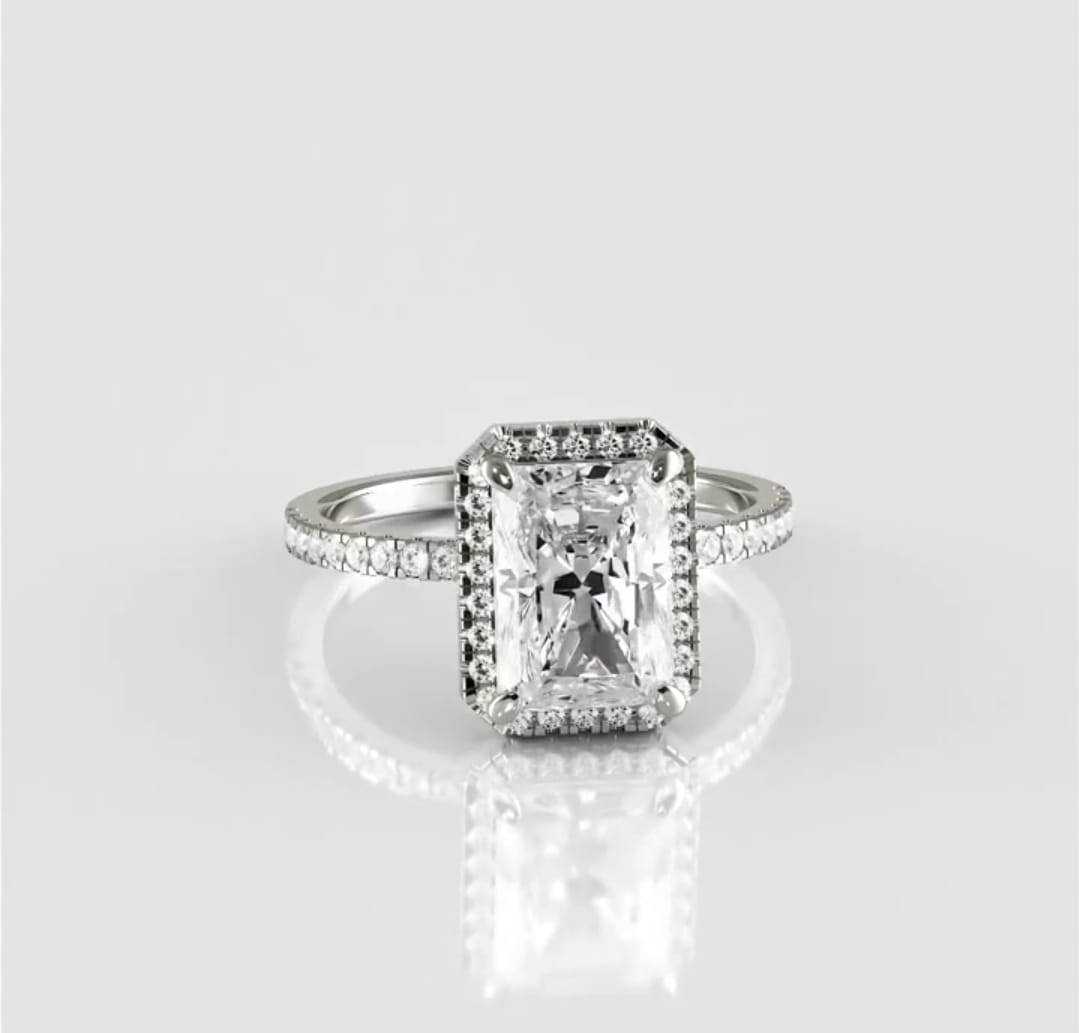 Straight-on top view of a breathtaking 3 carat radiant cut lab created diamond surrounded by a sparkling halo on a polished white metal band.