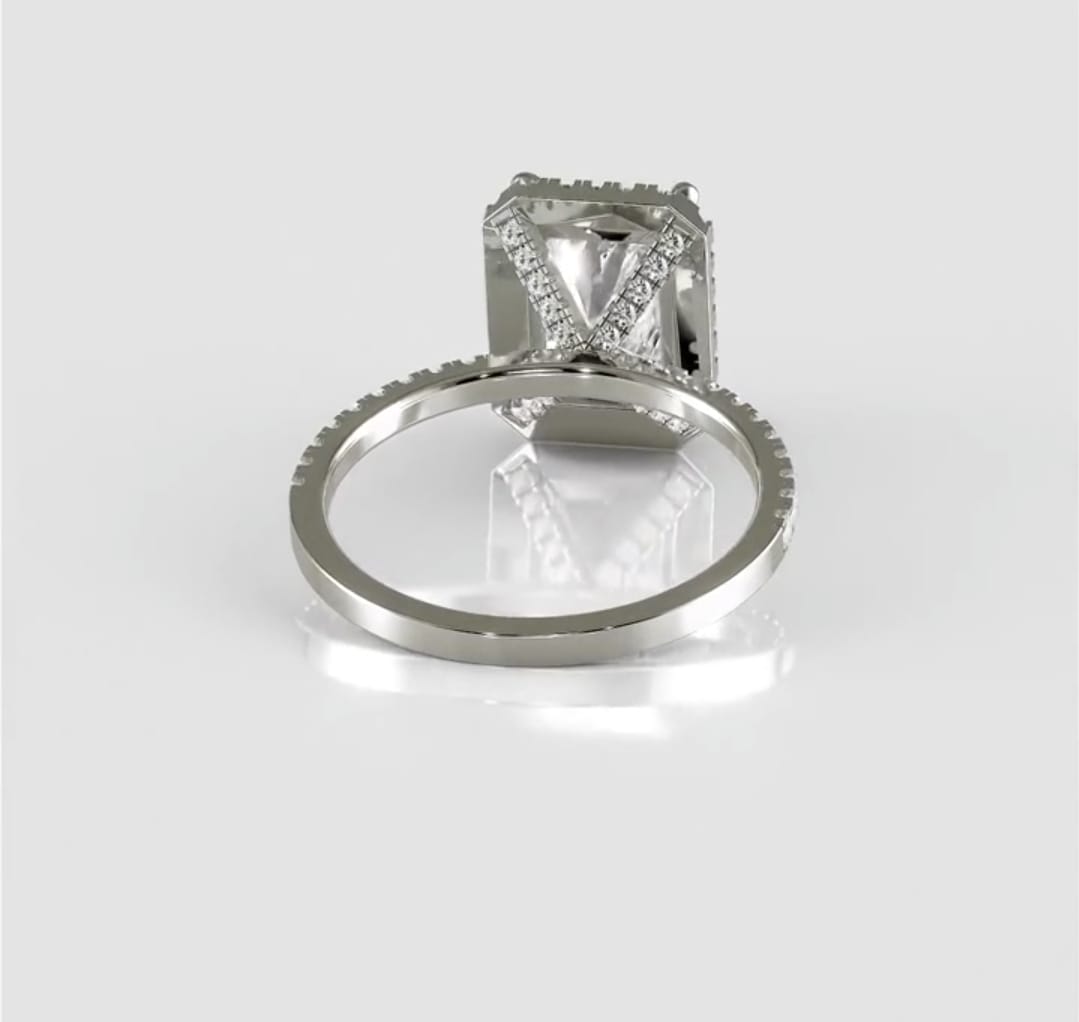 Lower angle view focusing on the unique diamond-studded V-shaped cross gallery beneath the 3 carat radiant center stone.
