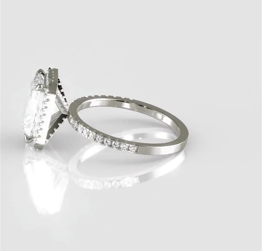 High-angle side profile displaying the elevated setting, radiant center diamond, and the seamless integration of the pavé shank.
