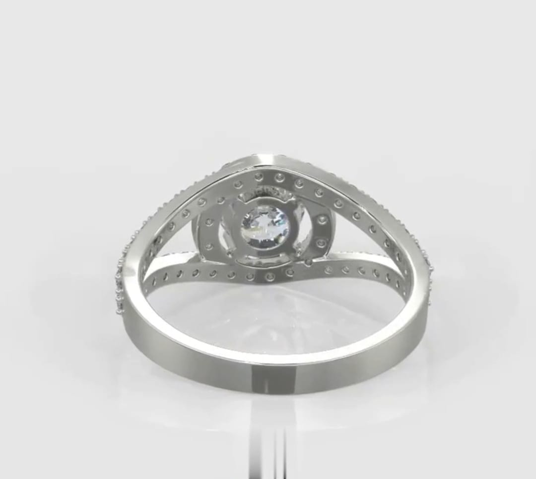 Underneath profile view of a 2 carat round lab grown diamond ring showcasing the intricate open gallery and pave diamond setting.