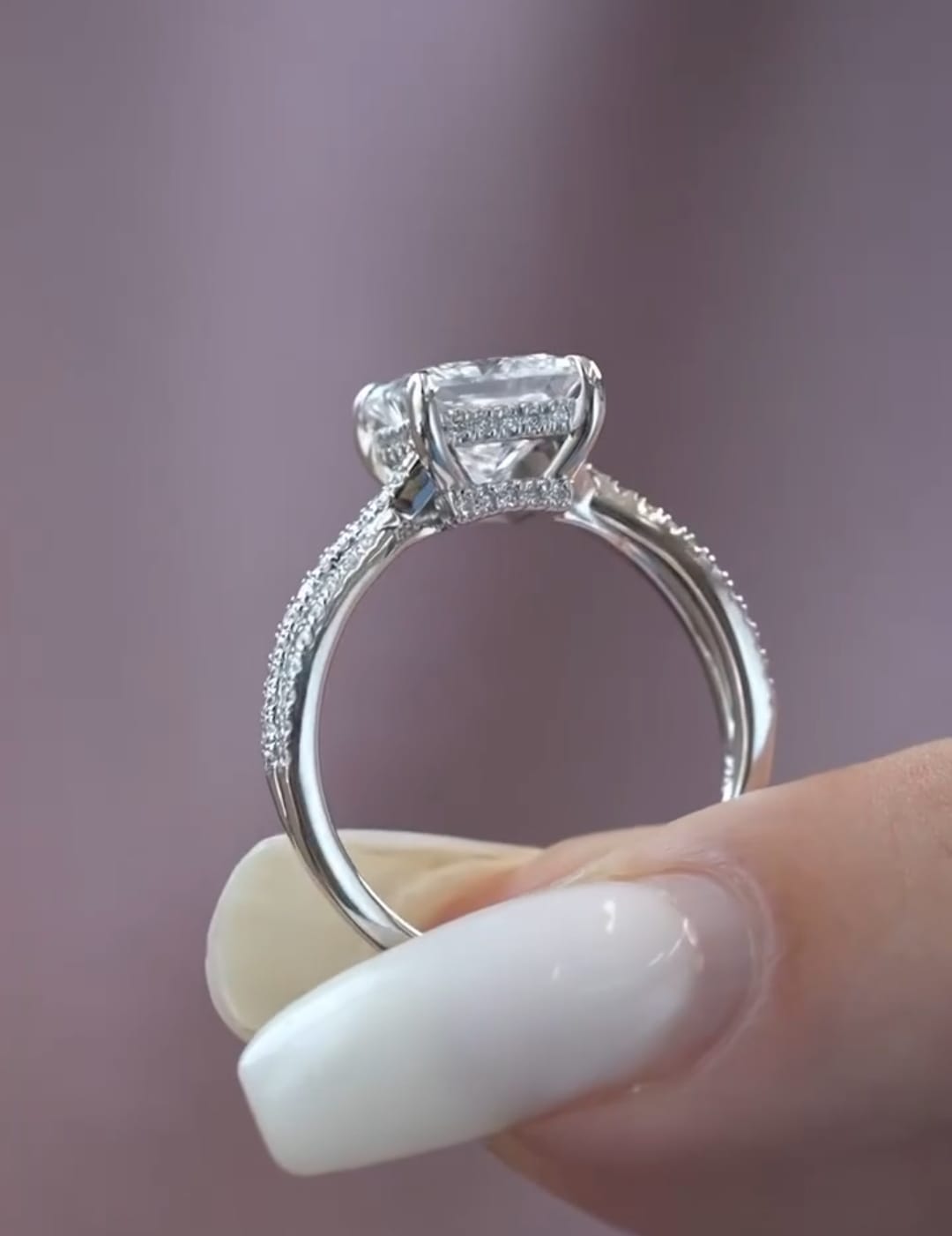 Side profile view of a 2 carat princess cut lab grown diamond ring displaying a delicate hidden halo and pavé diamond detailing on a white metal band.