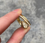 Front view of the beautifully nested 2 CT Pear Lab Grown Diamond Engagement Ring set resting on fingers.
