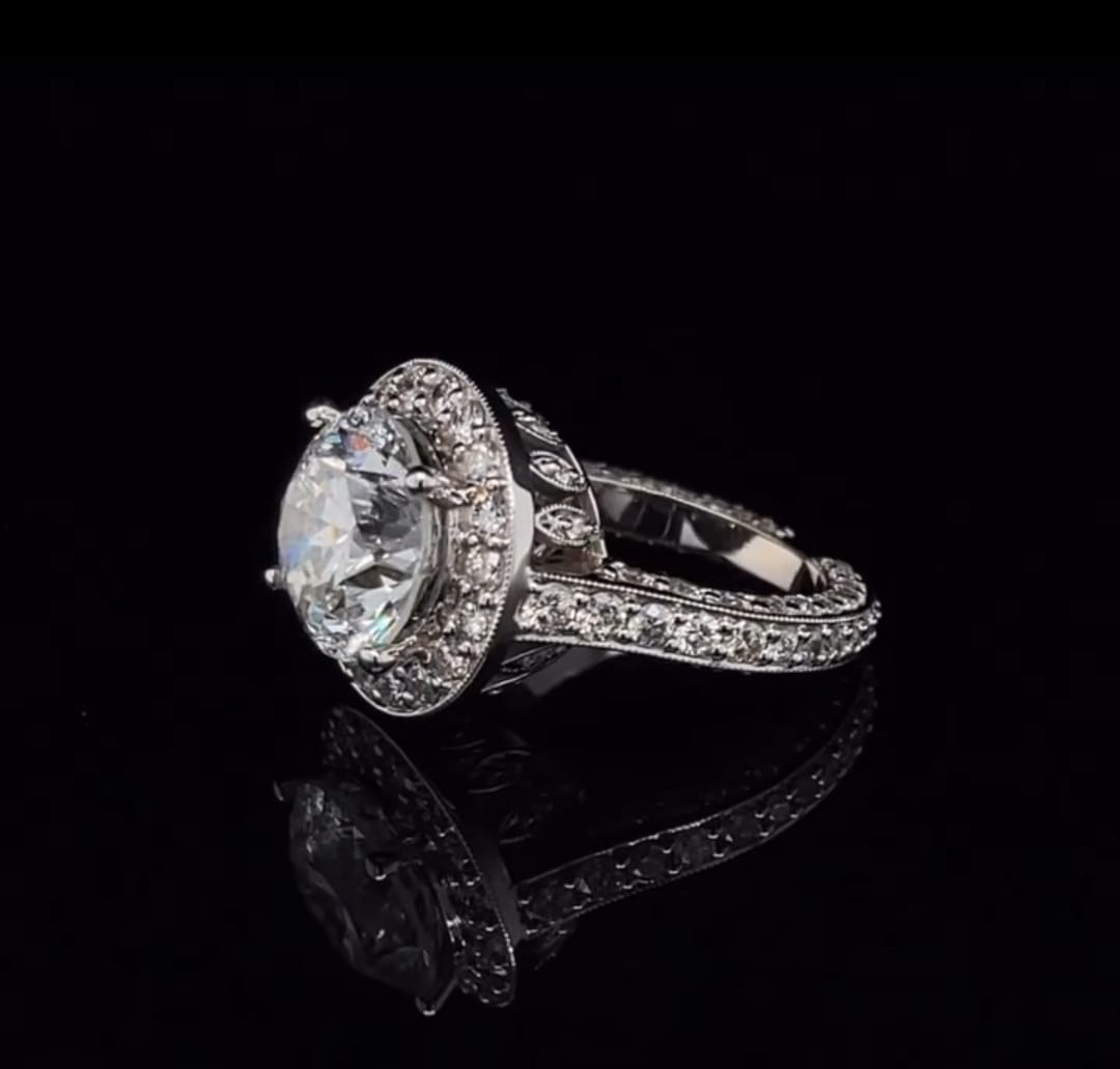 Side angle displaying the milgrain edging and pave setting on a 3 carat lab created diamond ring.