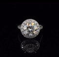 Top-down view showing a sparkling 3 carat round brilliant lab grown diamond encircled by a micro-pave halo.