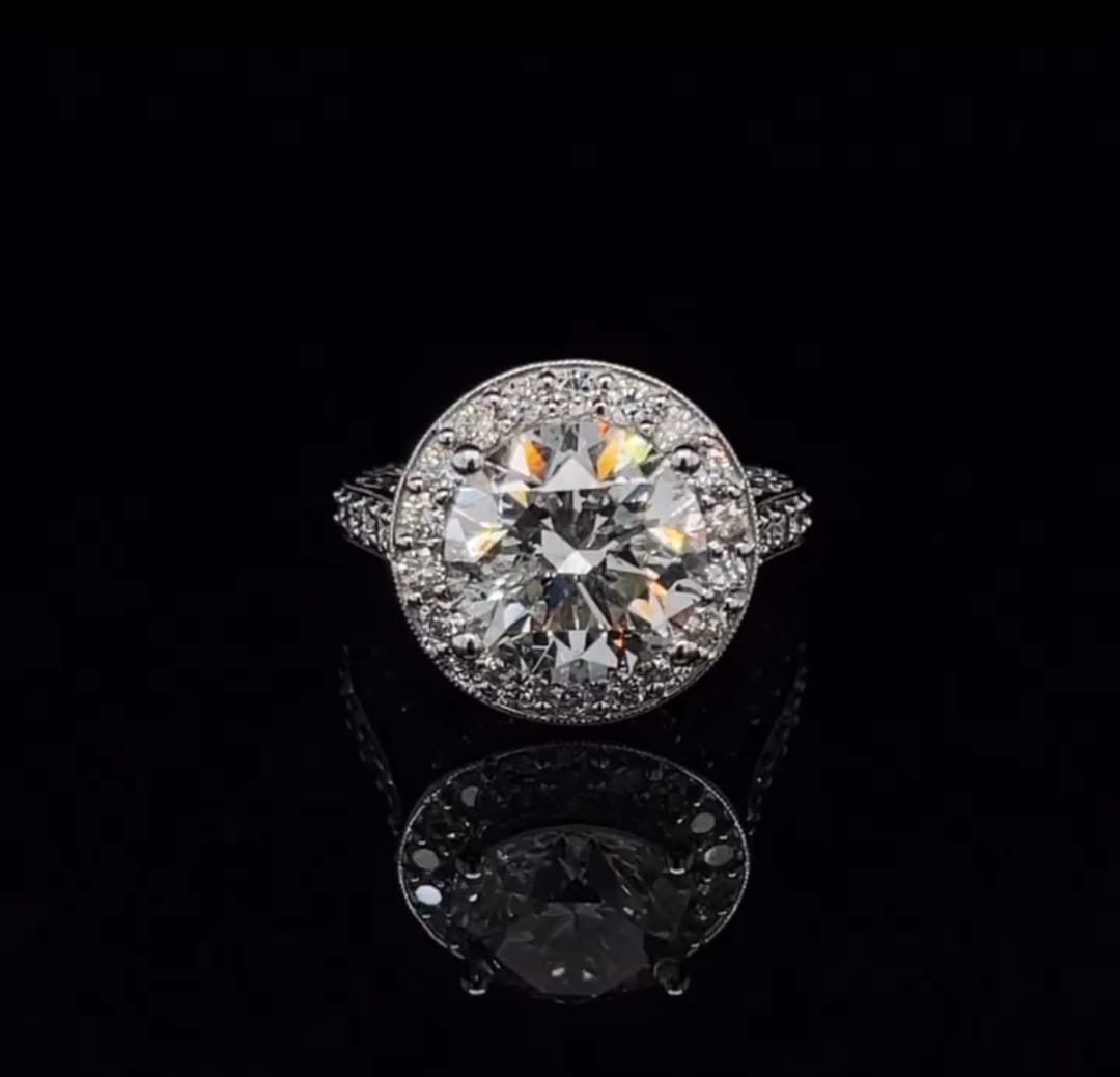 Top-down view showing a sparkling 3 carat round brilliant lab grown diamond encircled by a micro-pave halo.