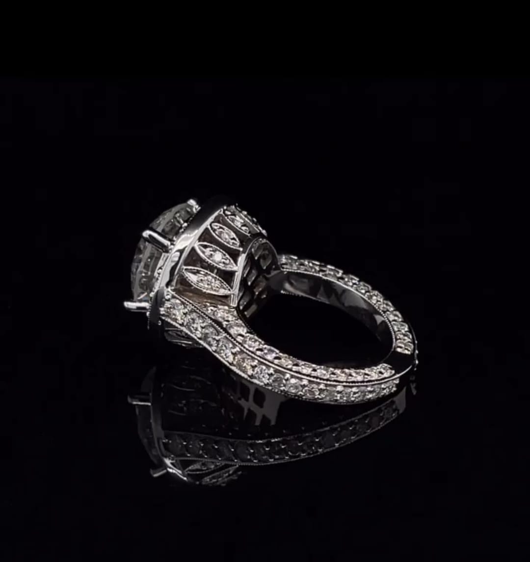 Profile angle showing the intricate diamond-accented basket and band of a white gold halo ring.