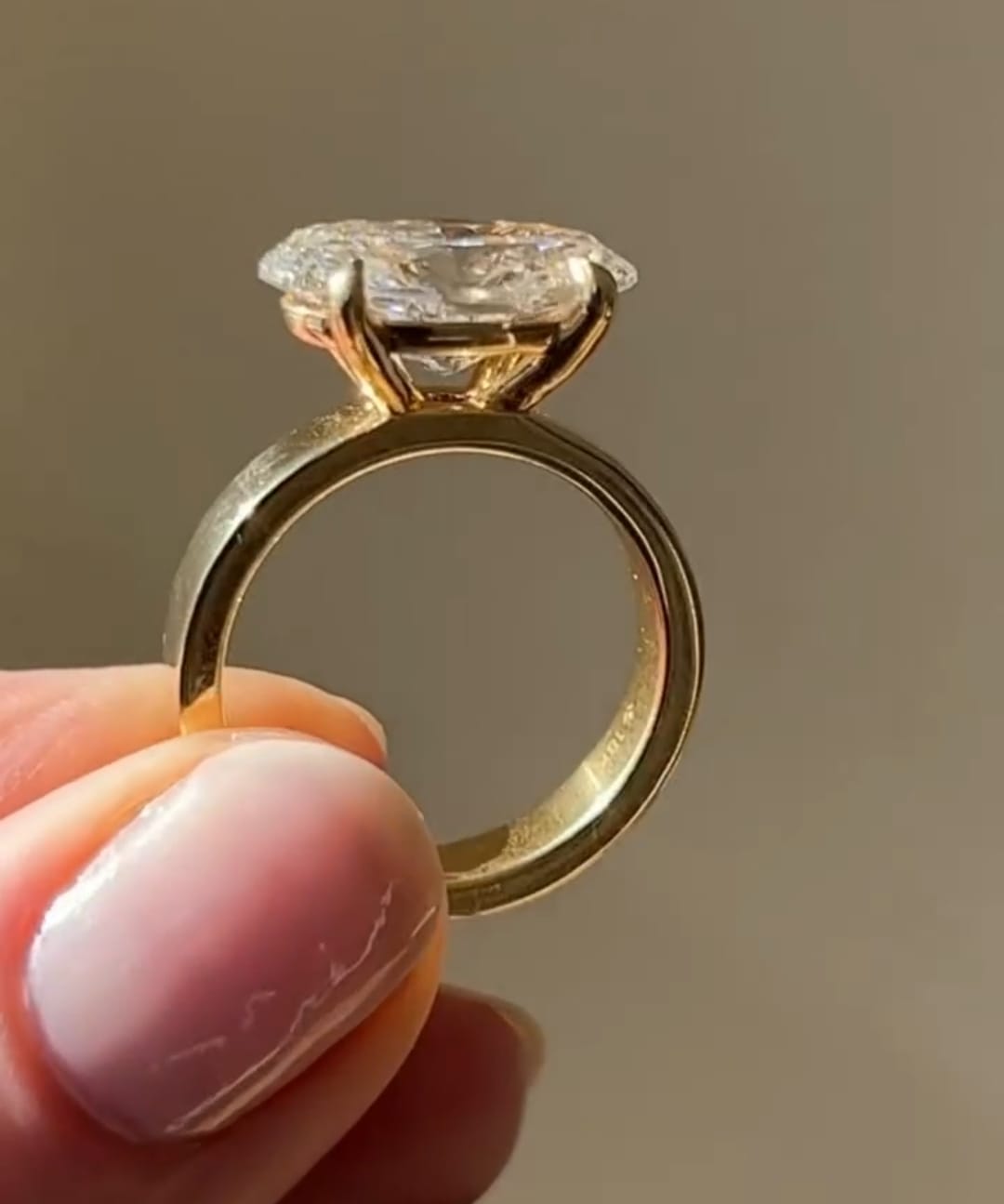 Side profile of 2 CT oval lab grown diamond ring with 4-prong setting in 18k yellow gold