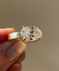 Close up top angle view of horizontally set 2 carat oval diamond engagement ring