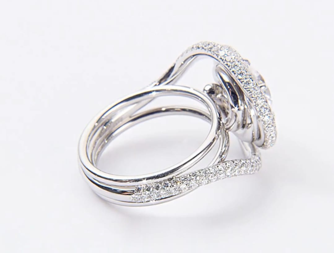 High angle profile view of pave-set spiral halo lab diamond engagement ring