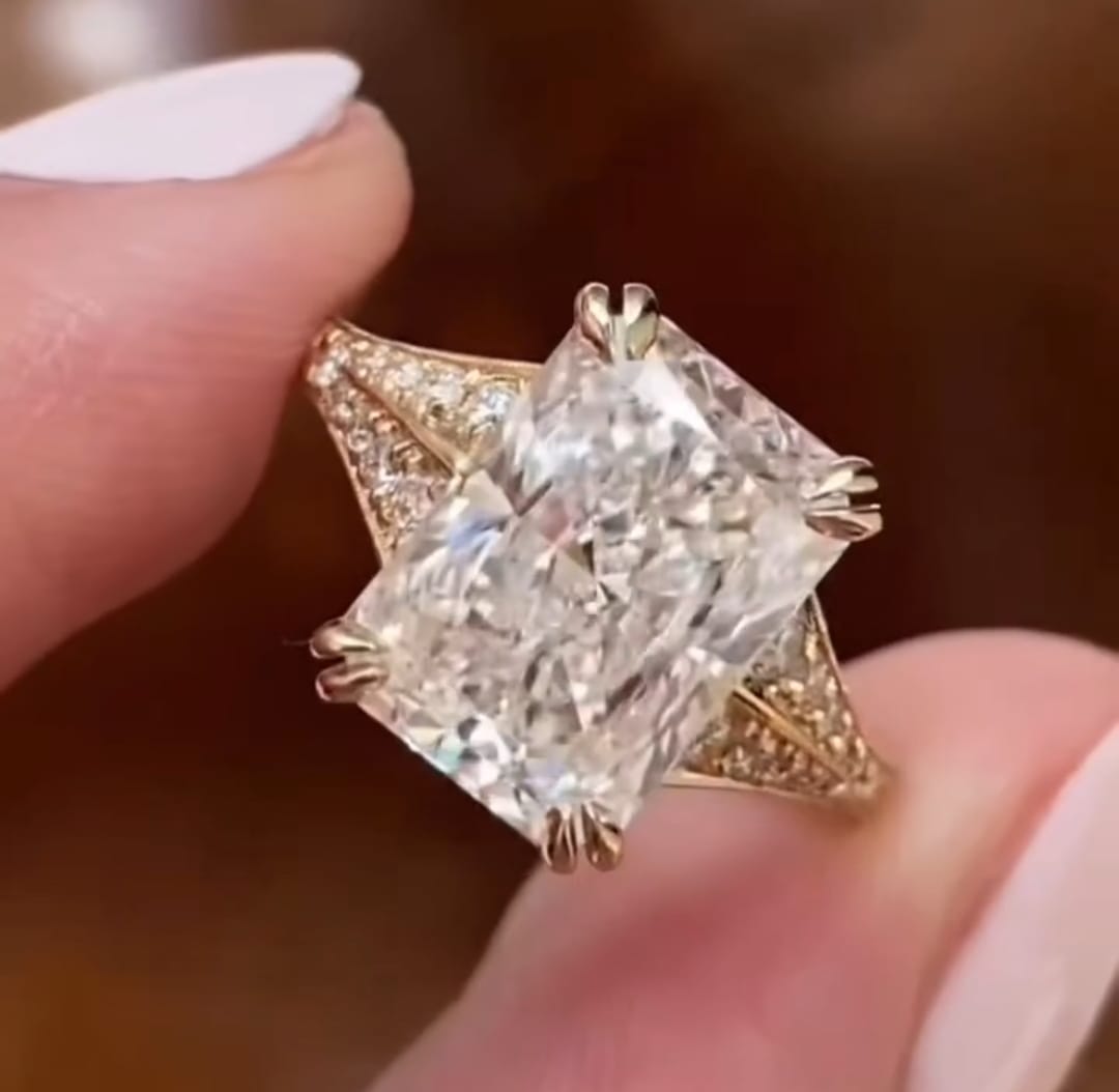 Direct top-down view of a 4 carat radiant cut lab grown diamond engagement ring in yellow gold.
