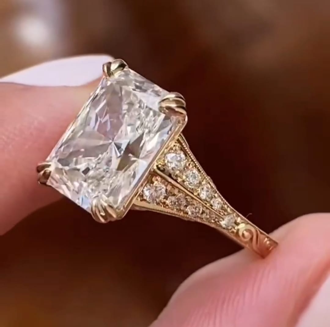 Macro view of pave diamonds on the split shoulders of a 4 CT radiant cut engagement ring.