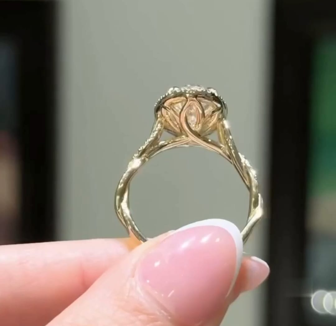 Inner view showing sculpted petal gallery basket under an oval lab diamond ring.