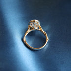 Full shot of 3 carat oval lab diamond halo ring on silk background showing twisted gold setting.