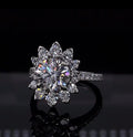 Close-up top angle of a 3 CT round lab diamond ring in white gold floral halo setting.