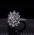 Close-up top angle of a 3 CT round lab diamond ring in white gold floral halo setting.