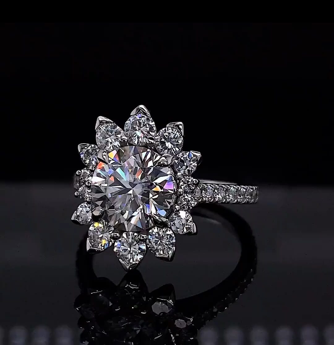 Close-up top angle of a 3 CT round lab diamond ring in white gold floral halo setting.