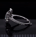 Side profile view of a sunburst halo setting on a white gold pavé diamond ring band.