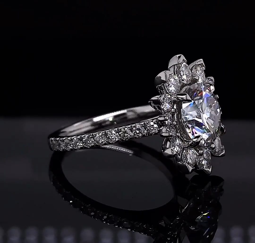 Angled view highlighting brilliant facets of 3 carat round lab diamond in floral setting.