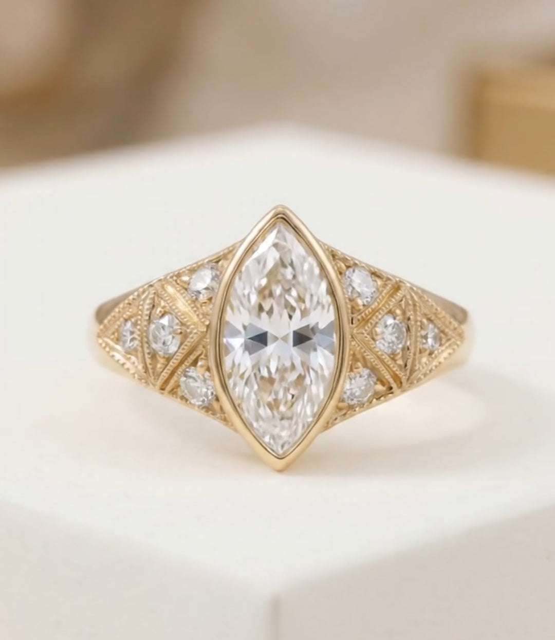 Close-up top view of a unique marquise engagement ring highlighting the bezel setting and triangular diamond side details.