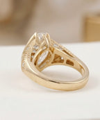 Side and band view of a yellow gold marquise engagement ring showing the tapered band and detailed under-gallery.