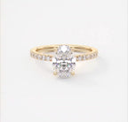 Top view of 2 carat oval cut lab grown diamond engagement ring in 14k yellow gold with pave band.