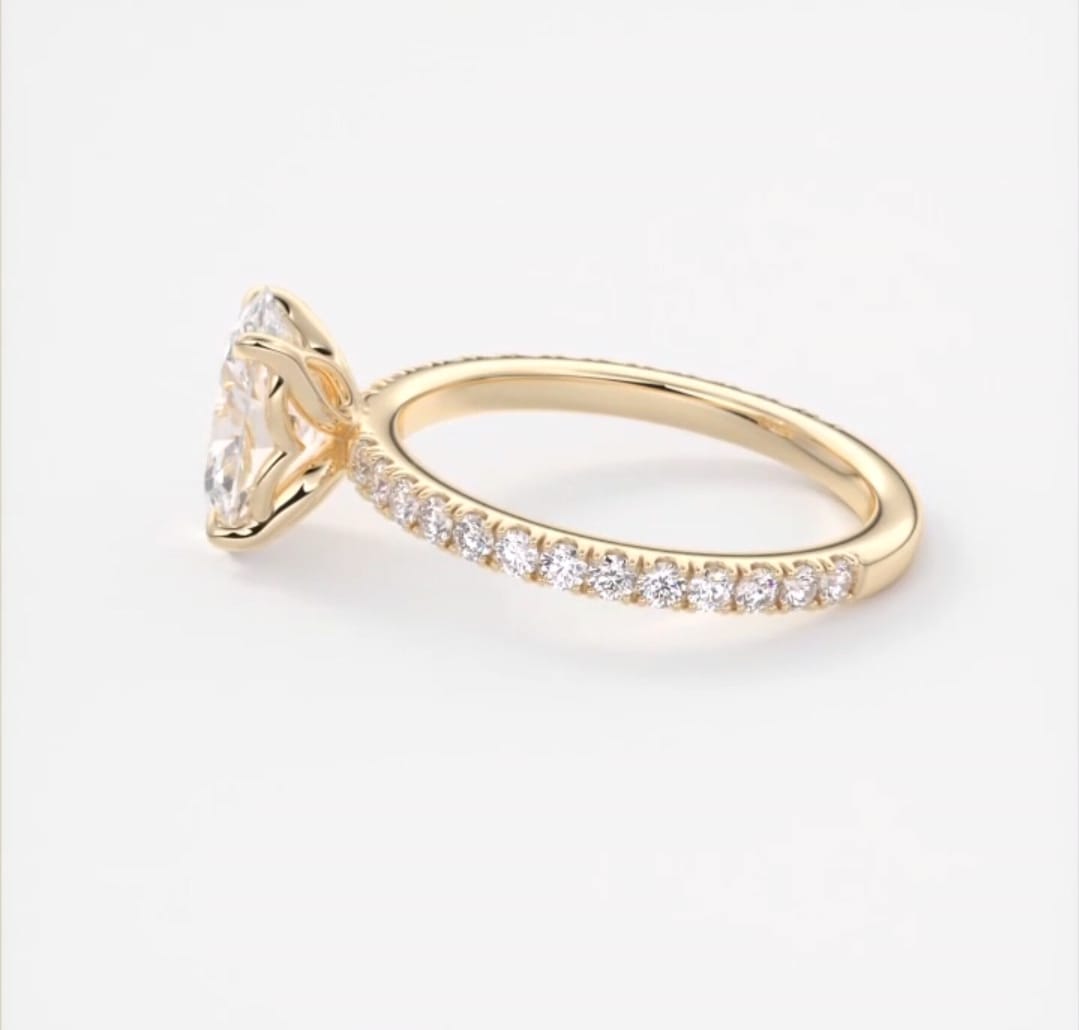 Side view showing yellow gold pave diamond band on a 2 CT oval lab diamond ring.
