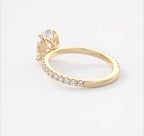 Profile angle highlighting the tulip petal basket setting of an oval lab grown diamond ring.