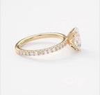 Side profile view showing delicate pave band alignment on a yellow gold oval engagement ring.
