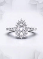 Front view of a 2 carat pear cut lab grown diamond engagement ring with floral sunburst halo in white gold.
