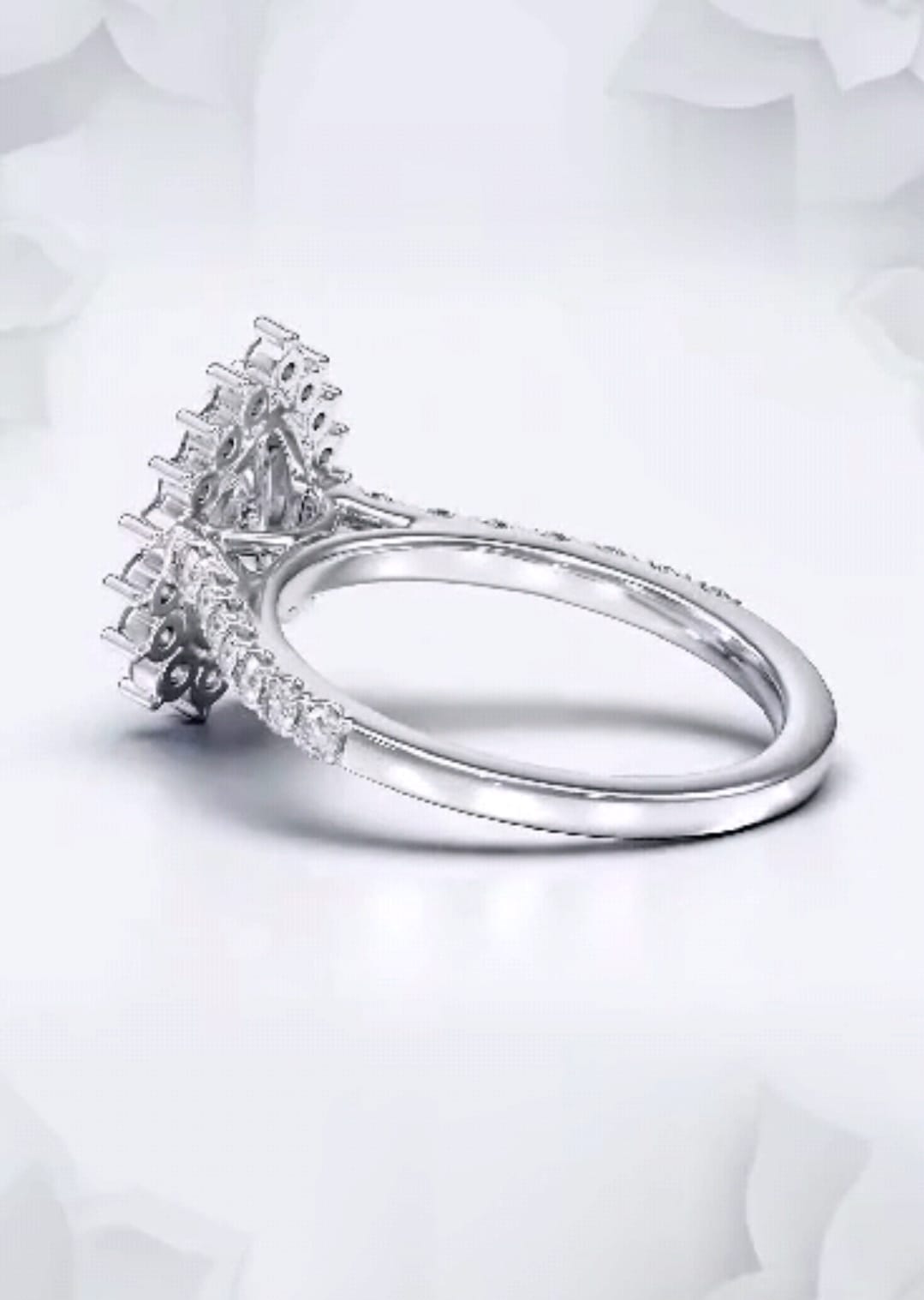 Side perspective showing the floral halo setting and pavé diamond band on a 2 CT pear lab diamond ring.