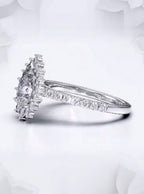 Three-quarter view of a pear shaped lab grown diamond ring featuring a delicate pavé accent band.