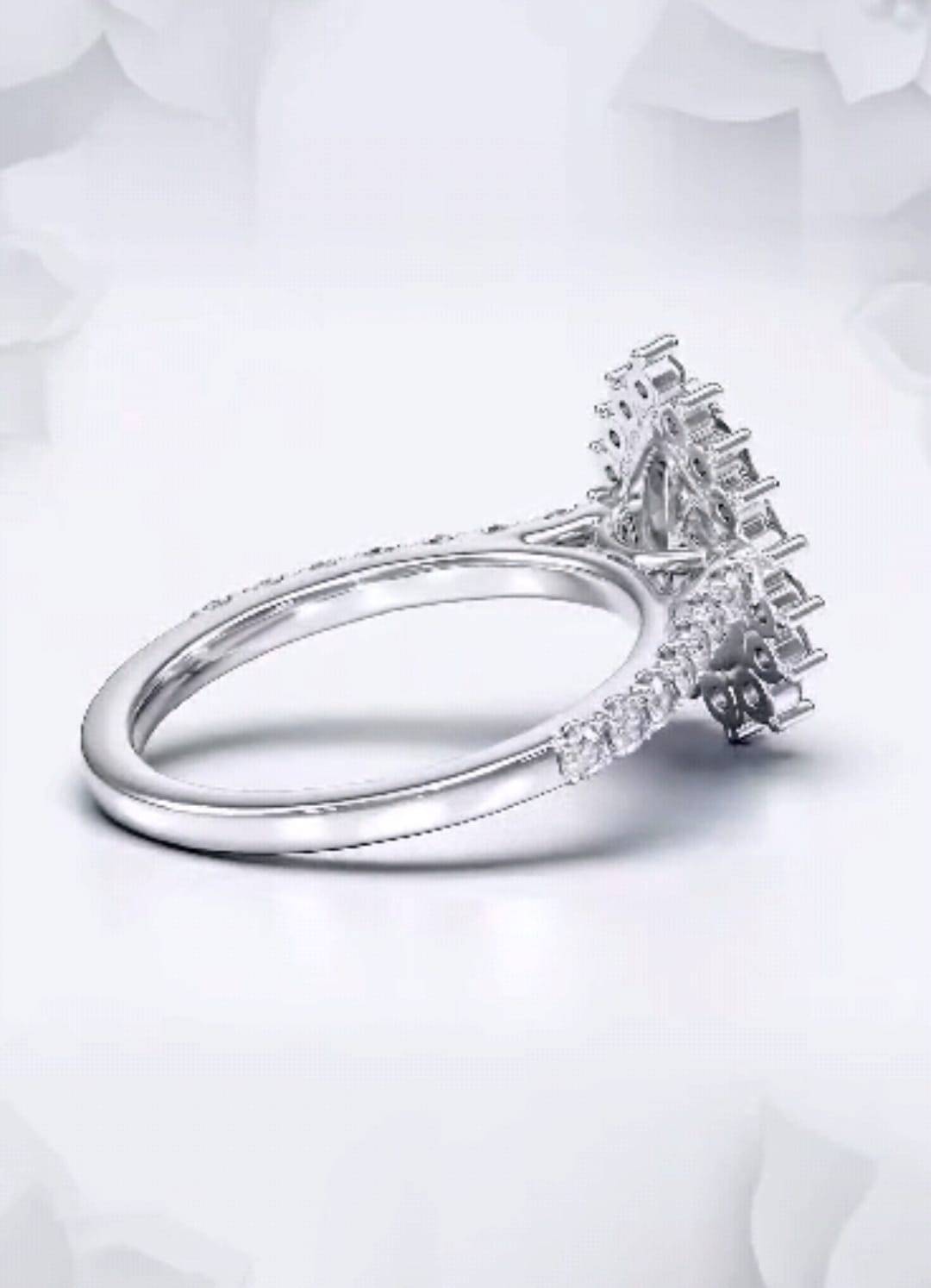 Profile angle displaying the elevated starburst halo basket on a white gold pear engagement ring.