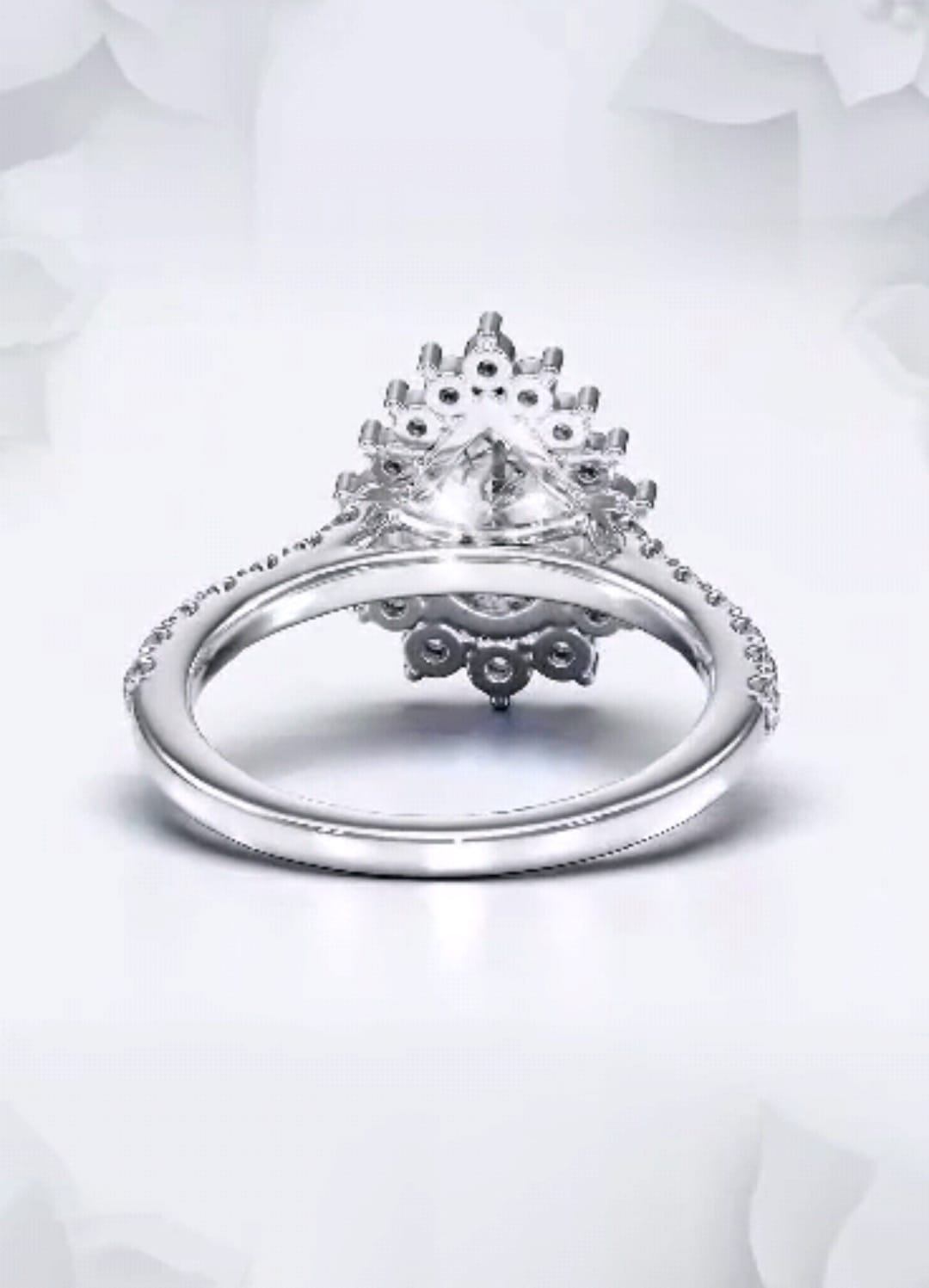 Underneath view showing the intricate petal basket design on a pear cut lab grown diamond ring.