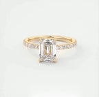 Top front view highlighting the clear step cut facets of a 2 carat emerald cut lab diamond ring.