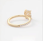 Profile angle focusing on the floral petal cathedral setting of a yellow gold engagement ring.