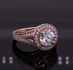 Angled view showing halo and split shank pave diamonds on rose gold ring