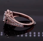 Side profile of rose gold engagement ring showing intricate filigree scrollwork