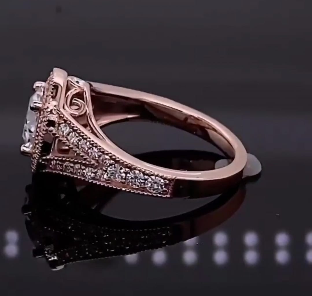 Side profile of rose gold engagement ring showing intricate filigree scrollwork