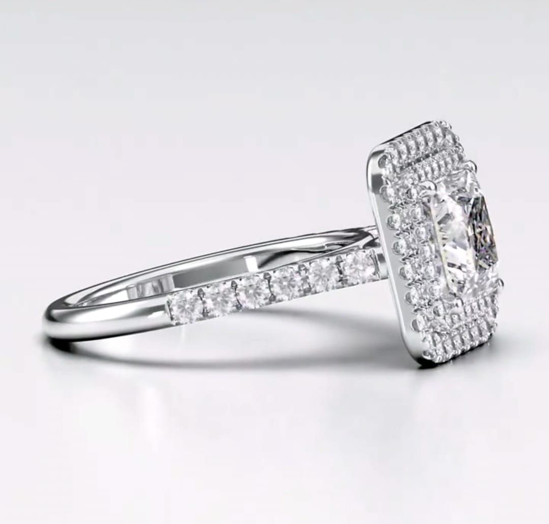 Angled view showcasing white gold pave band and double halo framing a princess cut diamond