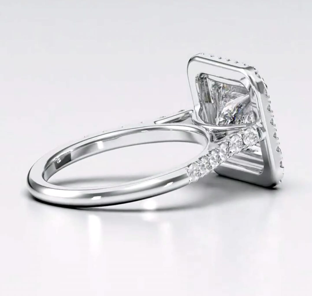 Back side profile view showing smooth polished white gold band and raised halo basket