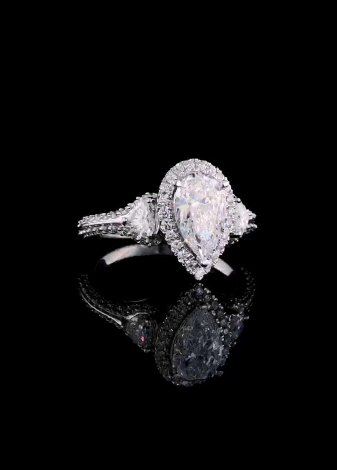 Angle view showing light sparkle on 3 carat pear lab diamond ring with micro-halo and pave split shank