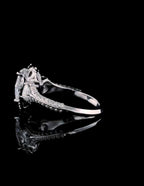 Close-up side view of white gold band and structural setting of pear cut lab diamond ring