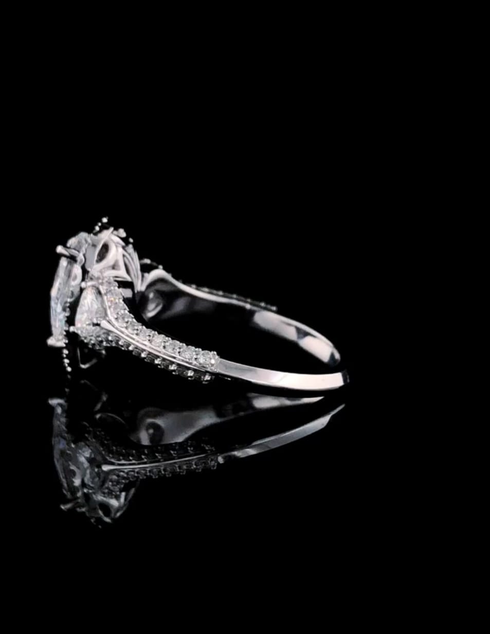 Close-up side view of white gold band and structural setting of pear cut lab diamond ring