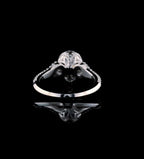 Rear perspective view of the polished lower shank and setting architecture of a 3 CT pear diamond ring