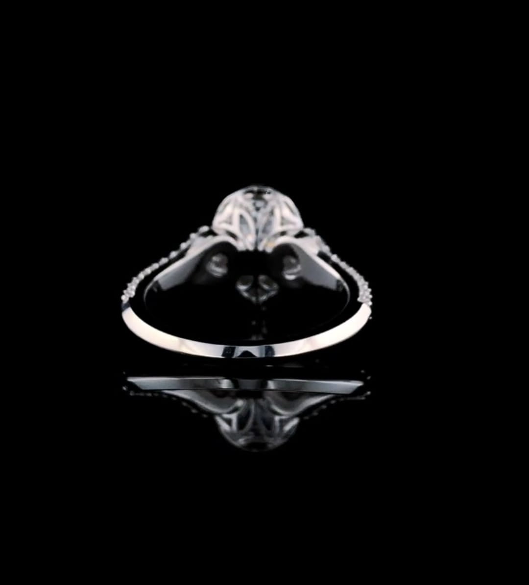 Rear perspective view of the polished lower shank and setting architecture of a 3 CT pear diamond ring